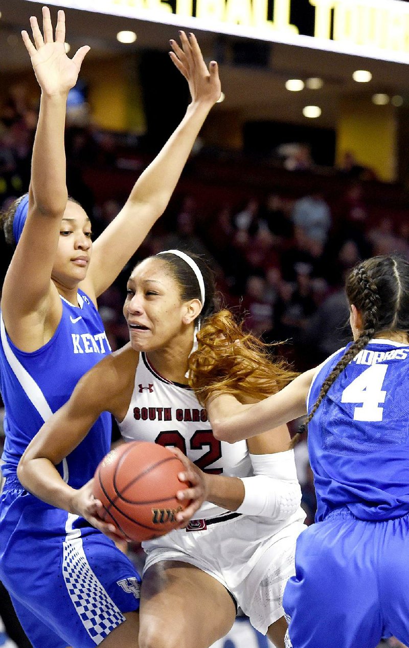 South Carolina forward A’ja Wilson (center) tries to go to the basket through Kentucky’s Alyssa Rice (left) and Maci Morris in the first half of the Gamecocks’ 89-77 victory in the semifi nals of the SEC Tournament in Greenville, S.C