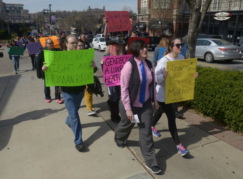 Shannon Hart (front row, left), student president of the University of Arkansas PRIDE group, and Jessica Stephenson lead marchers.