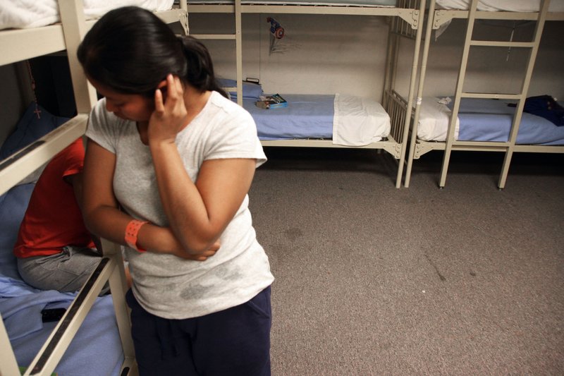 An unidentified Guatemalan woman stands inside a dormitory Sept. 10, 2014, in the Artesia Family Residential Center, a federal detention facility for undocumented immigrant mothers and children in Artesia, N.M. The nation’s immigration courts are already overwhelmed, facing a backlog of more than half a million cases. 