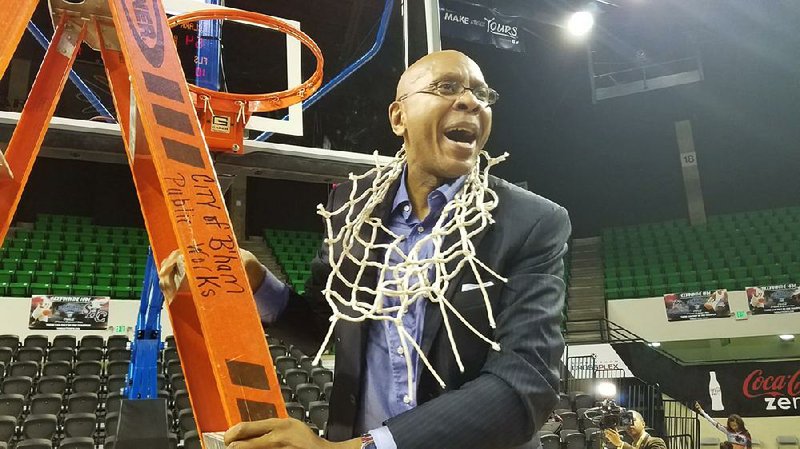 Clark Atlanta University Coach Darrell Walker, a former University of Arkansas, Fayetteville basketball player, celebrates after leading the Panthers to the NCAA Division II Tournament.
