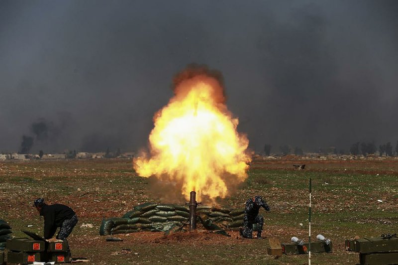 Iraqi security forces launch a rocket targeting Islamic State positions Sunday during fighting in western Mosul.