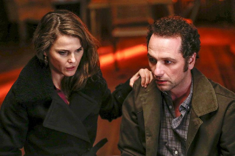 Keri Russell and Matthew Rhys portray married couple Elizabeth and Philip Jennings, Soviet spies deep undercover in a Washington suburb in the 1980s. The Americans returns at 9 p.m. today on FX.