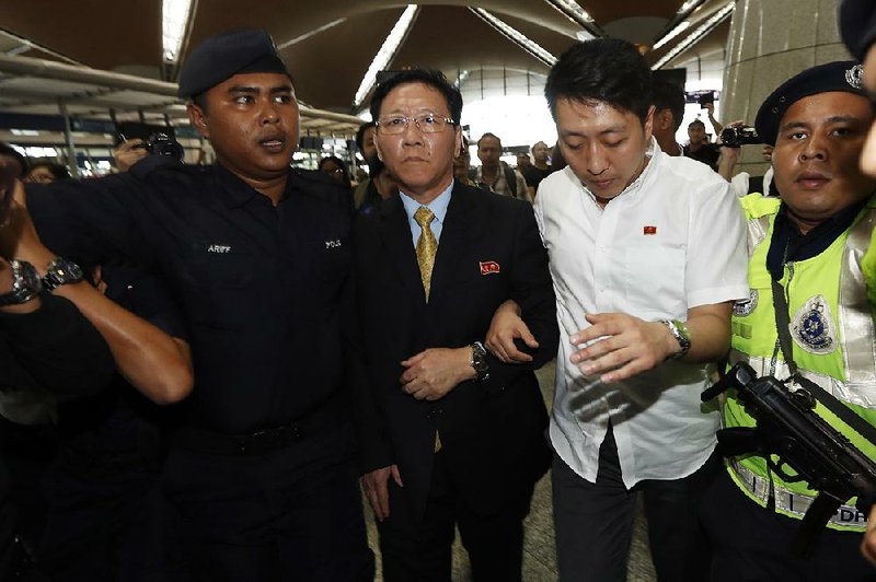 Kang Chol (center), North Korea’s ambassador to Malaysia, arrives Monday at Kuala Lumpur International Airport in Sepang, Malaysia.