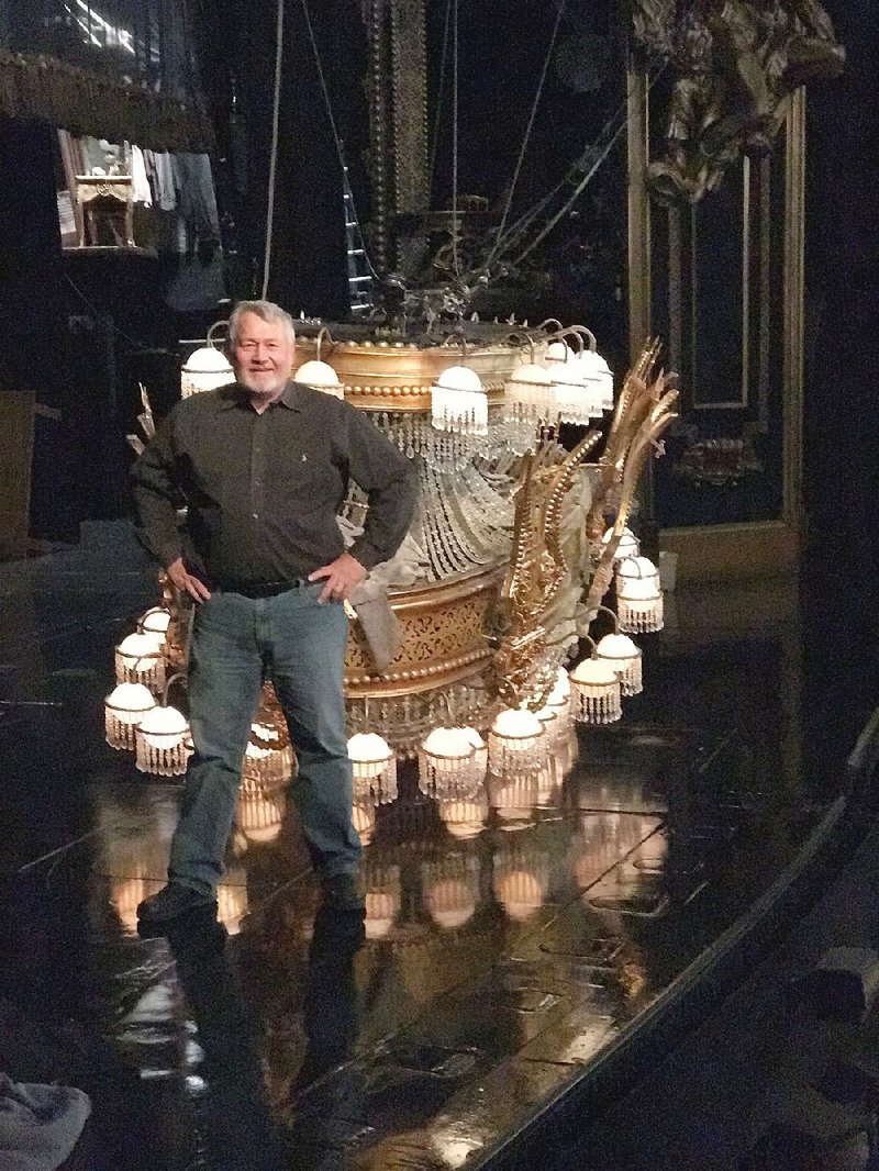 Arkansas native and Broadway technical production manager Jake Bell poses with the chandelier from The Phantom of the Opera in New York.