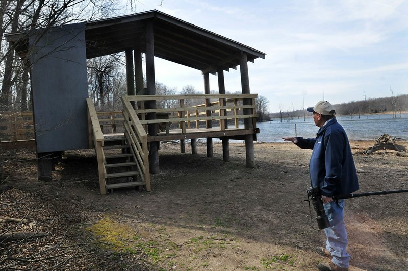 Terry Stanfill shows improvements to the original wildlife viewing pavilion near Swepco Lake at the end of Eagle Watch Trail. The one-half mile path takes visitors through forests and meadows.