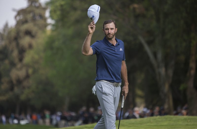 Dustin Johnson, of the United States, celebrates winning the Mexico Championship at Chapultepec Golf Club in Mexico City, Sunday, March 5, 2017. Johnson won the Mexico Championship in his debut as the No. 1 player in the world. 