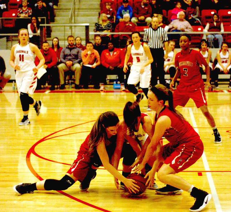 Photo by Mark Humphrey/Enterprise-Leader/Farmington freshman Makenna Vanzant, shown competing against Russellville in February, battles two defenders for possession of the basketball. Farmington defeated Batesville in first-round tourney action, 60-55, on March 1.