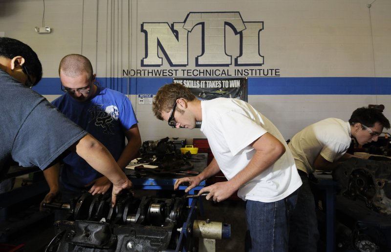 A Bentonville High School student rebuilds a car engine during class at Northwest Technical Institute in Springdale. A bill to allow schools districts to form regional training centers passed the House on Tuesday.