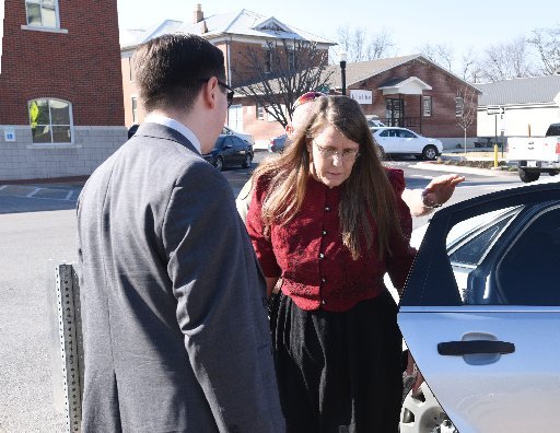 Cathy Torres of Bella Vista arrives Wednesday with one of her attorneys, Tony Pirani, at the Benton County Courthouse annex in Bentonville.