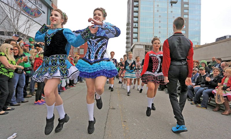 In this file photo  Mary Kate Donahue (left) and Katherine Teske do an Irish dance and Sarah Moore and Ben Moore (far right) do another during a performance from the O'Donovan School of Irish Dance in North Little Rock. 