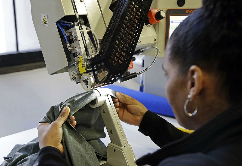 A seamstress works last week at clothing manufacturer 99 Degrees Custom in Lawrence, Mass. A government report Wednesday said that worker productivity grew at slower annual pace in the last quarter of 2016. 
