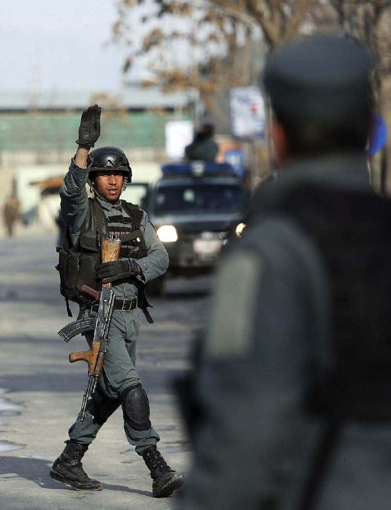 Security forces control the scene of an attack on a military hospital Wednesday in Kabul, Afghanistan.