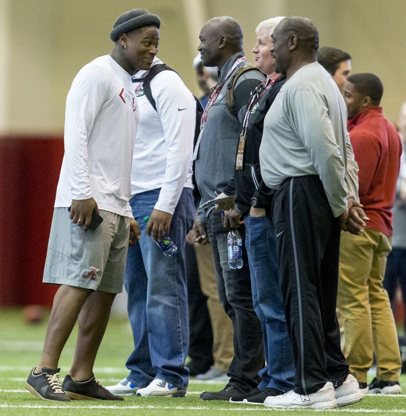 Former Alabama linebacker Reuben Foster talks with New York Jets head coach Todd Bowles during Alabama's pro day, Wednesday, March 8, 2017, at the Hank Crisp Indoor Facility in Tuscaloosa, Ala. 