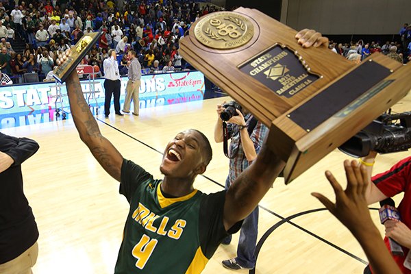 Little Rock Mills senior Darious Hall holds the Class 5A state championship and championship game MVP trophies following a 65-61 win over Little Rock Parkview on Thursday, March 9, 2017, in Hot Springs. 