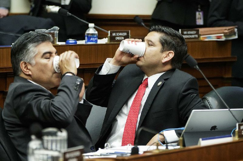 Rep. Tony Cardenas, (left) D-Calif., and Rep. Raul Ruiz, D-Calif., take a break Thursday as members of the House Energy and Commerce Committee argue the details of the GOP’s health care bill.