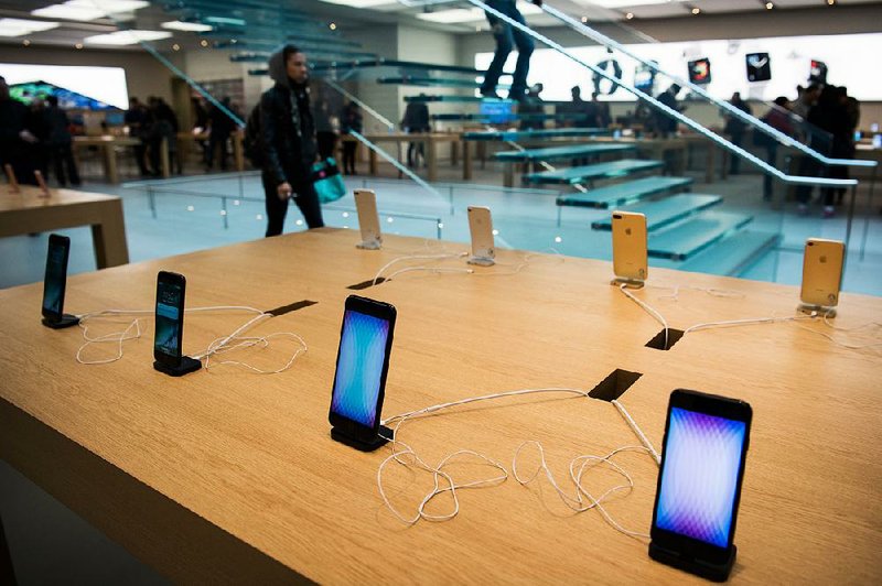 Apple Inc. iPhones are displayed at a store in the SoHo neighborhood of New York, in this file photo. The supply chain for making Apple products faces interruption if lawmakers approve import tariffs or a comprehensive border tax.