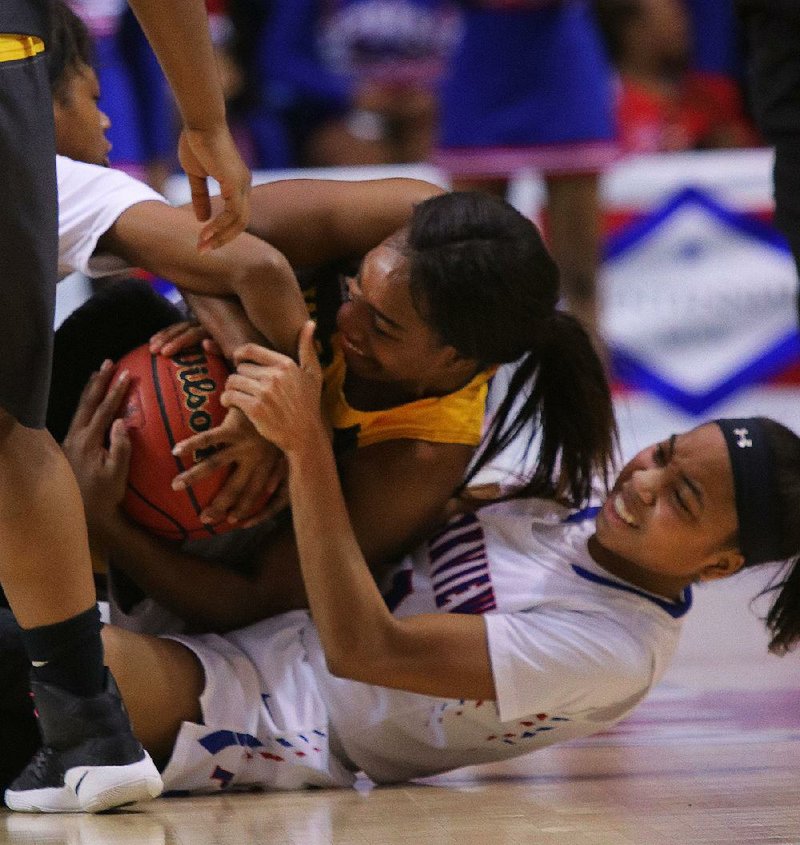 Little Rock Parkview’s Mikayla Alexander (top left) and Kania Lasker (bottom right) battle for a loose ball with Watson Chapel’s Timesha Cole during the Lady Wildcats’ 64-46 victory in the Class 5A girls state championship game in Hot Springs. More photos available at arkansasonline.com/galleries.