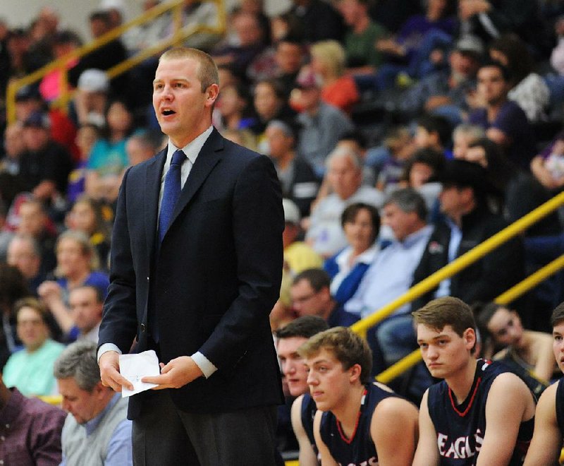 Baptist Prep coach Brian Ross directs his team against Ozark Saturday, Feb. 27, 2016, during the first half of play in the championship game of the 4A North Regional Tournament in Tiger Arena in Prairie Grove. Visit nwadg.com/photos to see more photographs from the game.