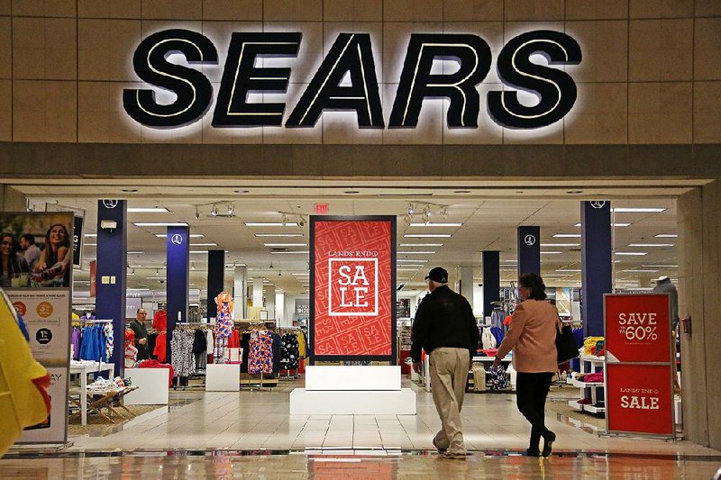 Shoppers enter a Sears store in Pittsburgh in February. The Hoffman Estates, Ill.-based company said it lost $607 million, or $5.67 per share, in the fourth quarter.