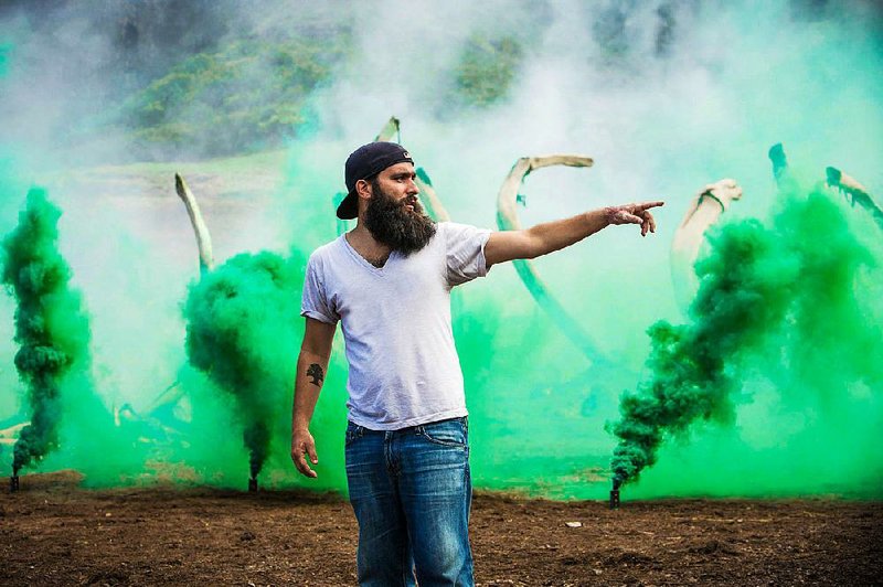 Lushly bearded director Jordan Vogt-Roberts makes an executive decision on the set of Kong: Skull Island.