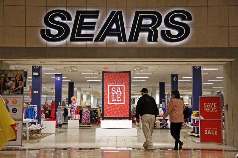 FILE - In this Wednesday, Feb. 8, 2017, file photo, shoppers walk into a Sears store in Pittsburgh. Sears Holdings Corp. on Thursday, March 9, 2017, reported a loss of $607 million in its fiscal fourth quarter. (AP Photo/Gene J. Puskar, File)