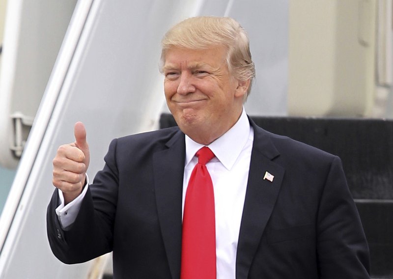 FILE - In this Friday, March 3, 2017, file photo, U.S. President Donald Trump gestures as he walks down the stairs of Air Force One upon his arrival at Palm Beach International Airport in West Palm Beach, Fla. China has granted preliminary approval for 38 new Trump trademarks, fueling concerns about conflicts of interest and preferential treatment of the U.S. president. The marks pave the way for branded spas, golf clubs, hotels, and even private body guard and escort services in China _though it&#x2019;s not clear if those businesses will actually materialize. (AP Photo/Luis M. Alvarez, File)