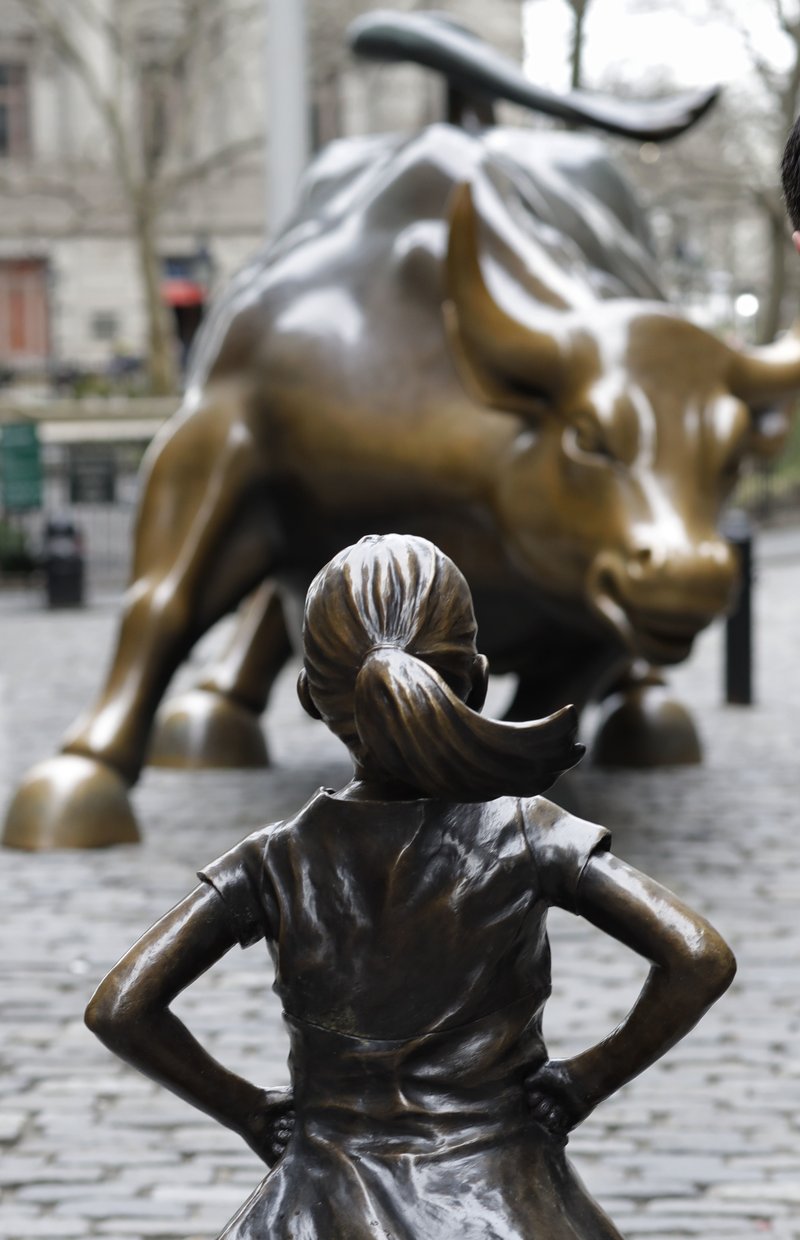 A statue titled "Fearless Girl" faces the Wall Street bull, Wednesday, March 8, 2017, in New York.  