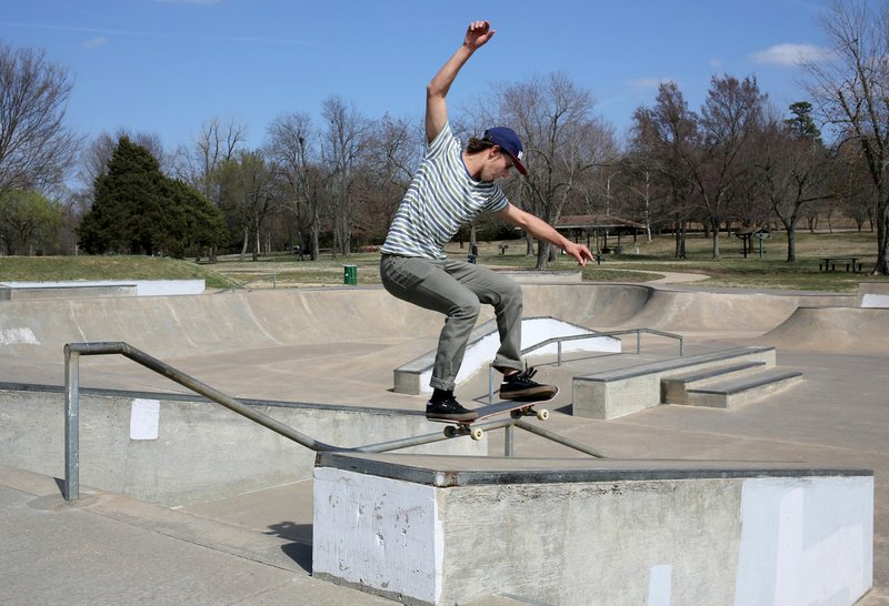 Jared Henry, a member of the pAth Outfitters skateboard team, does a 50-50 trick Thursday on a rail at the skateboard park at Walker Park in Fayetteville. Fayetteville’s Parks and Recreation Department held a public input session Thursday at the Fayetteville Senior Activity and Wellness Center about Walker Park’s plan.