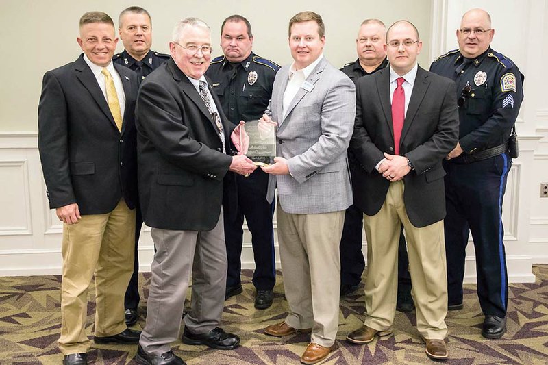 Nathan Price, front row, third from left, 2016 president of the Arkadelphia Chamber of Commerce Board of Directors, presents the Distinguished Service Award to the Arkadelphia Police Department. Accepting the award are, front row, from left, Assistant Chief Jason Jackson, Chief Al Harris, Sgt. Dustin O’Brien; and, back row, Sgt. Dean Palmer, Sgt. Andy Williams, Sgt. Robert Jones and Sgt. Don Cleek.