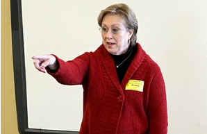 The Sentinel-Record/Richard Rasmussen CITY AND MAYOR: Mayor Ruth Carney calls on a student for a question during her presentation Friday to fourth-graders in the campus library at Park International Baccalaureate Magnet School. Students compared the role of a fictional mayor character in a book they read recently with the duties of Carney's real position.