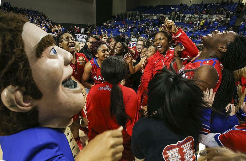 Marion players, students and the school mascot celebrate Friday after the Lady Patriots defeated the Sheridan Lady Yellowjackets 50-40 for the Class 6A girls state championship in Hot Springs. For more photos, visit arkansasonline.com/galleries.