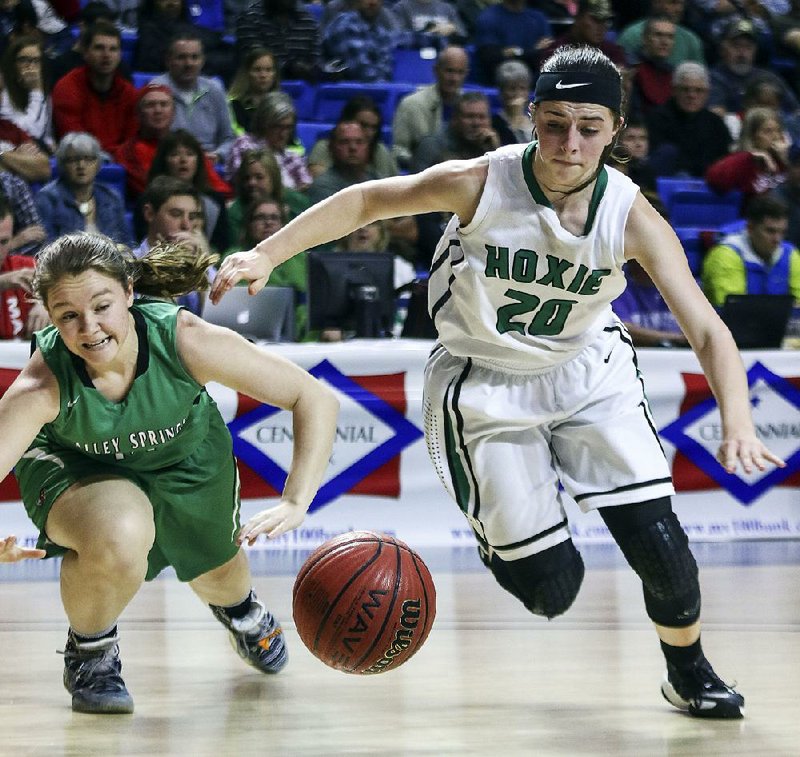Hoxie’s Devyn Pollard (20) and Valley Springs’ Gabbi Shearer try to run down a loose ball Friday during the Lady Mustangs’ 51-40 victory over the Lady Tigers in the Class 3A girls state championship game in Hot Springs. For more photos, visit arkansasonline.com/galleries.