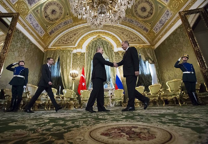 Russian President Vladimir Putin (center) welcomes Turkish President Recep Tayyip Erdogan to the Kremlin on Friday.