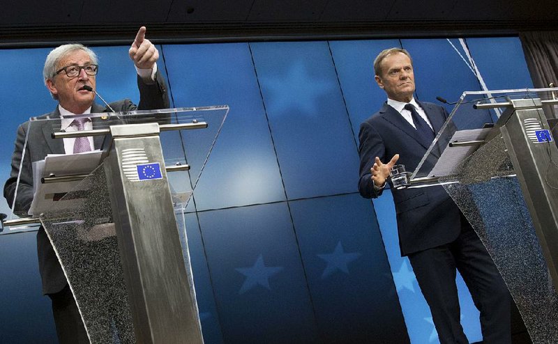 European Commission President Jean-Claude Juncker (left) and European Council President Donald Tusk talk to journalists Friday at the end of an EU summit in Brussels. 