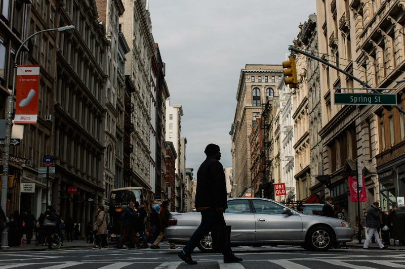 A pedestrian crosses Broadway in the SoHo neighborhood of Manhattan last week. 