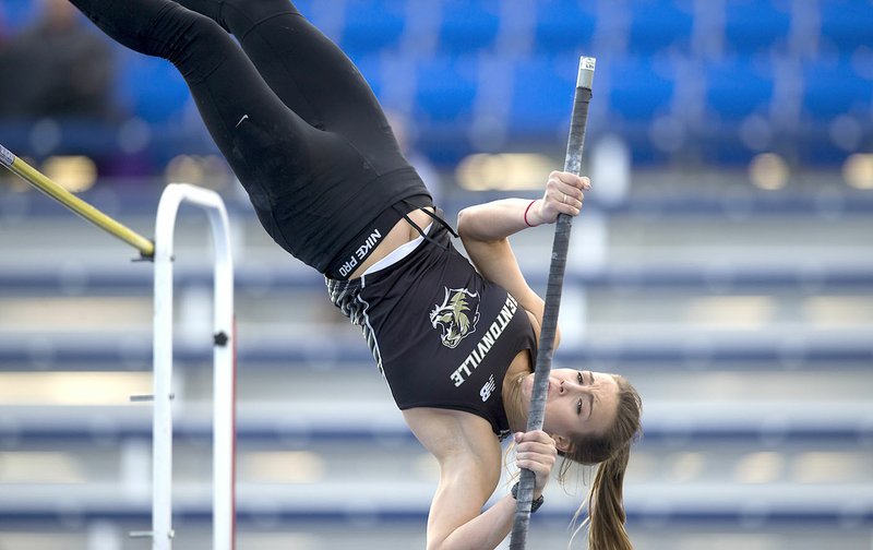 Bentonville High senior Isabel Neal competes in the pole vault Friday during the Whitey Smith Relays at Rogers High School.