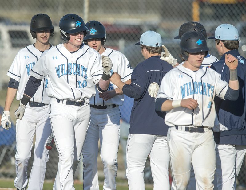 Blake Adams (10) of Springdale Har-Ber celebrates a home run with teammates Friday after leaving the yard against Mountain Home at Tyson Sports Complex in Springdale.