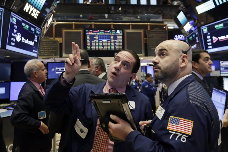 Traders Tommy Kalikas, center, and Fred DeMarco, right, talk as they work on the floor of the New York Stock Exchange, Friday, March 10, 2017. Stocks are moving higher in early trading on Wall Street after the government reported solid job gains in the U.S. in February. (AP Photo/Richard Drew)