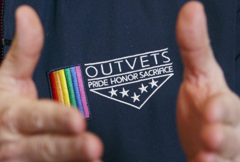 OutVets founder Bryan Bishop wears the logo of his group while speaking with a reporter at his house in Boston, Friday, March 10, 2017. 