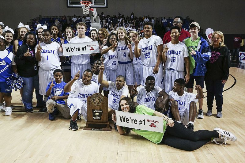 Members of Conway’s Project Unify team pose with their championship trophy after beating Forrest City in the Division A title game Friday at Bank of the Ozarks Arena in Hot Springs. 