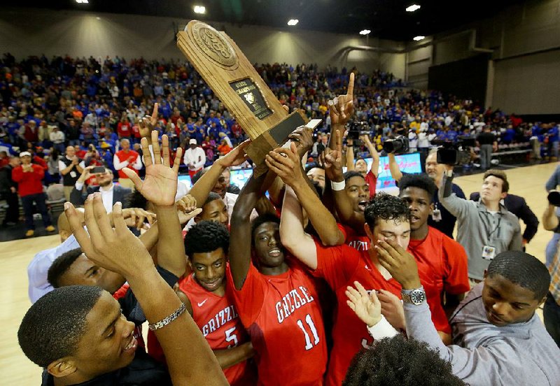 Fort Smith Northside players celebrate with the Class 7A championship trophy Saturday after beating North Little Rock 50-49 at Bank of the Ozarks Arena in Hot Springs. For more photos, visit arkansasonline.com/galleries. 