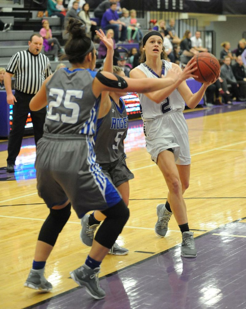 Fayetteville guard Sasha Goforth (2) drives to the basket as she is fouled by Rogers forward Madison Sandor (25) Friday, Feb. 10, 2017, during the first half of play in Bulldog Arena. 