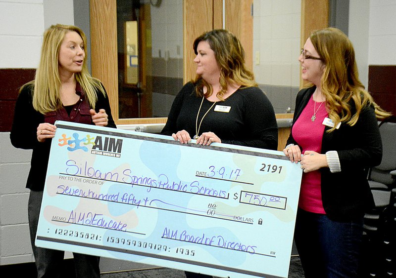 Janelle Jessen/Siloam Sunday Michelle Sauer, speech language pathologist for Southside Elementary, received a $750 grant from the Autism Involves Me organization during Thursday&#8217;s school board meeting. The grant money will be used to purchase new items for the school&#8217;s sensory room. Sauer wrote the grant along with teacher Cynthia Brown.