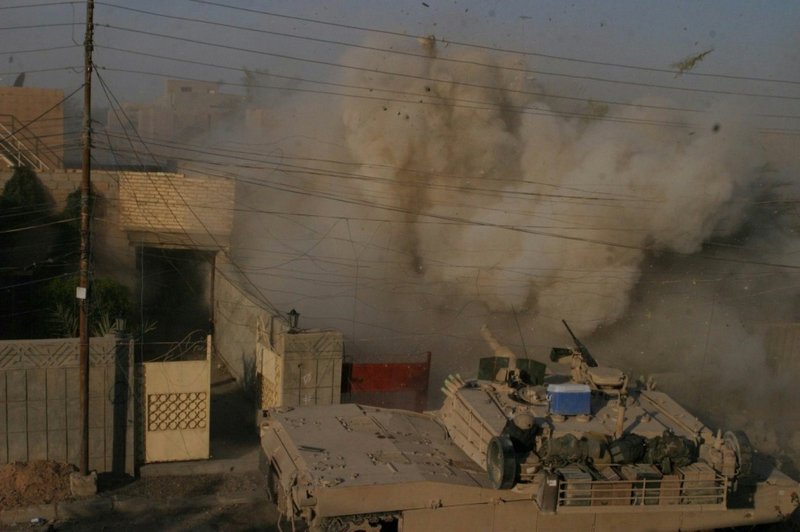 An M1A1 Abrams tank with the 2nd Tank Battalion fires into a building that Marines received fire from during a battle in Fallujah in 2004. 