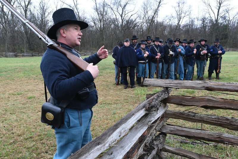 NWA Democrat-Gazette/FLIP PUTTHOFF Frank Siltman (left) explains Saturday the process of artillery fire in the Civil War during the living history program at Pea Ridge National Military Park. The Battle of Pea Ridge was fought March 6-8, 1892.