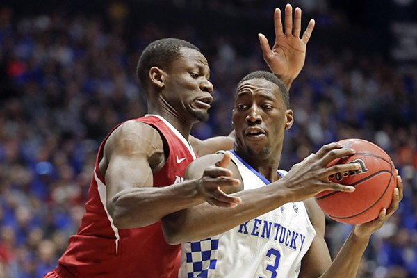 Arkansas forward Moses Kingsley, left, pressures Kentucky forward Edrice Adebayo (3) in the first half of an NCAA college basketball game for the championship of the Southeastern Conference tournament Sunday, March 12, 2017, in Nashville, Tenn. 