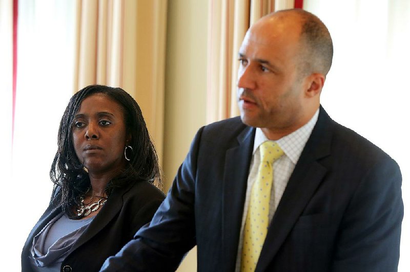 FILE — Sylvia Perkins, left, mother of Bobby Moore III,  listens as her attorney Michael J. Laux answers questions in this 2015 file photo.
