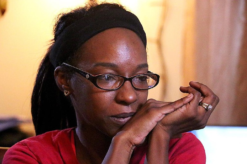 Roseetta Robinson cries at her Memphis home as she describes the death of her father, Cletis Wayne Williams, who was shot by a white Jonesboro police officer on Halloween 2011.