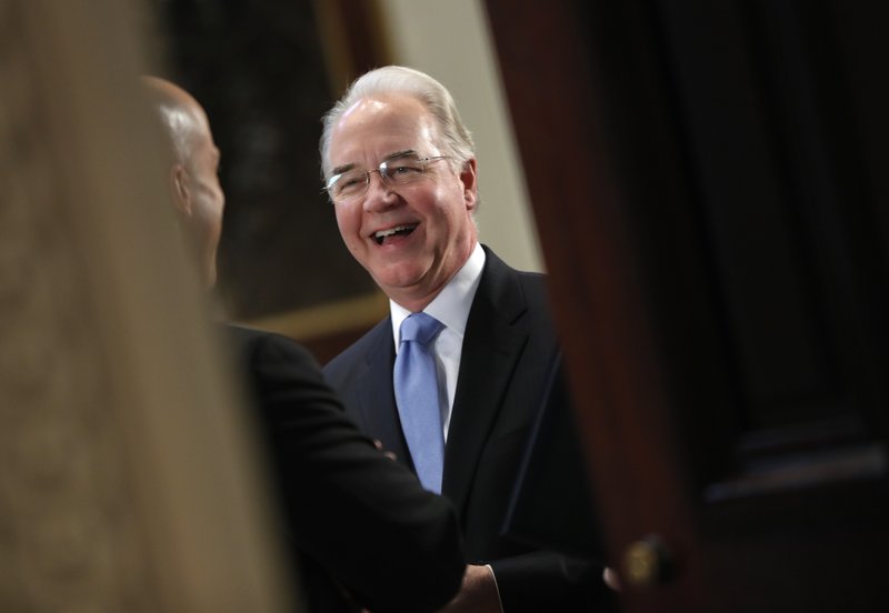 Health and Human Services Secretary Tom Price talks with a guest as they wait for the arrival of Vice President Mike Pence to begin a meeting with conservative groups to discuss healthcare, Friday, March 10, 2017, in the Indian Treaty Room of the Eisenhower Executive Office on the White House complex in Washington. 