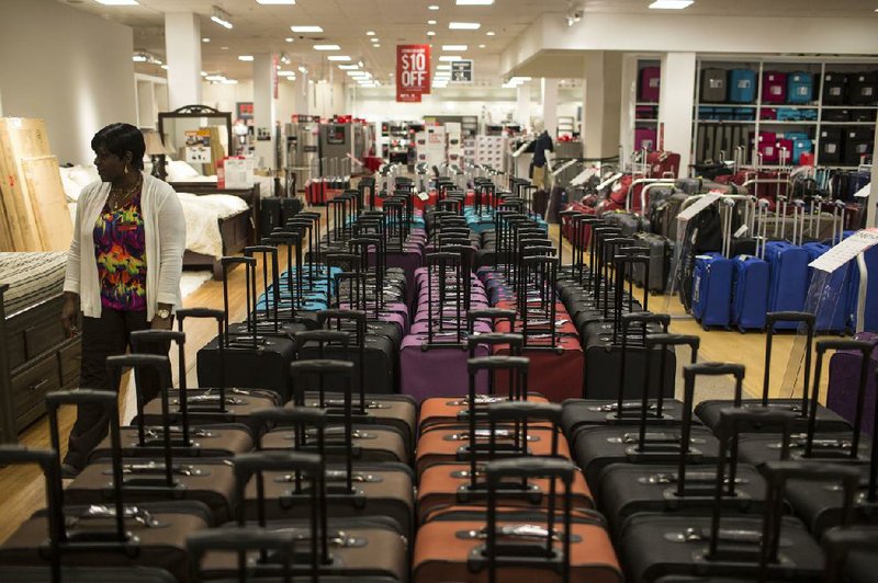 A woman shops in a JCPenney Co. store in the Roosevelt Field Mall in Garden City, N.Y., in this file photo. Some investors see failing commercial mortgage loans as opportunities to profit from a collapse of shopping malls.